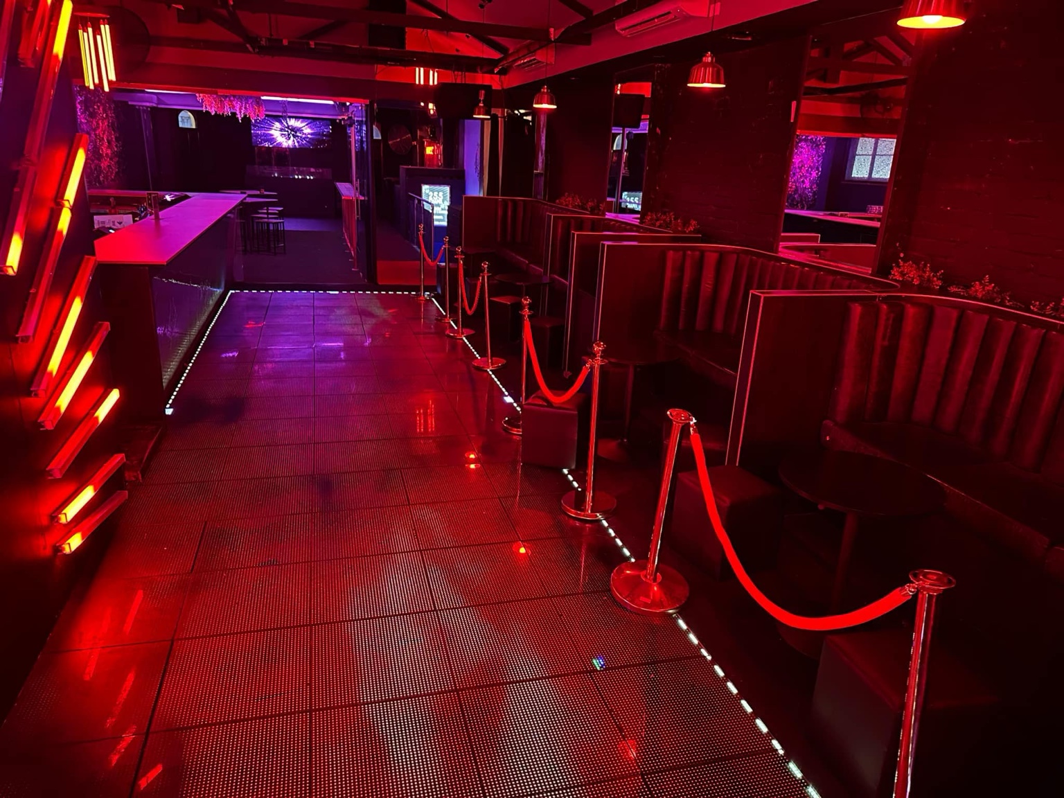ATTIK's red-lit main floor and private booths