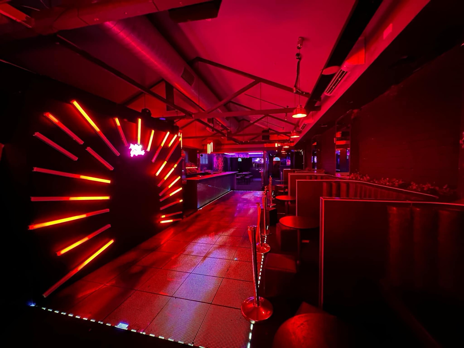ATTIK red-lit room and booths